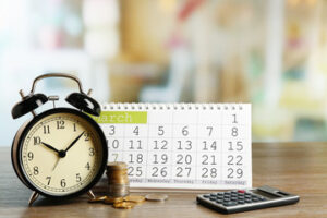 Person using a digital clock app to track work hours and surving the purpose of Time Calculator